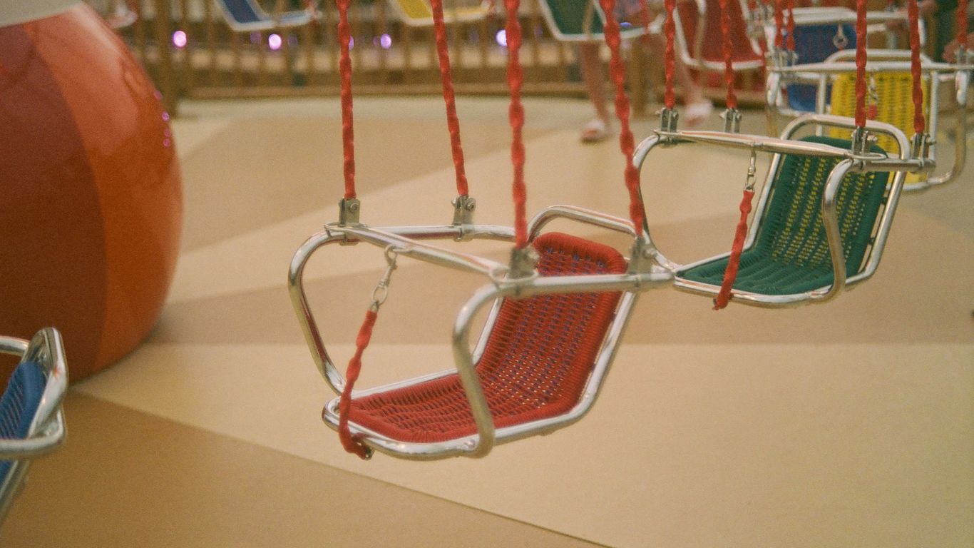 a shopping cart with a red and white basket on it