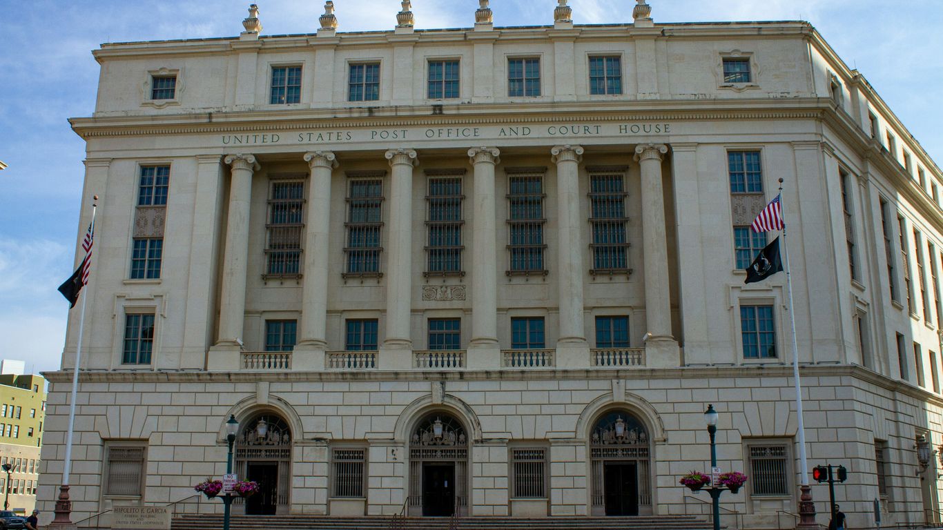 a large white building with a flag on top of it