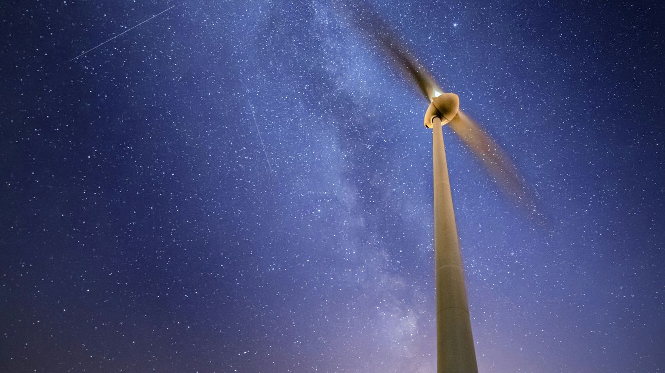 white and black wind turbine under blue sky