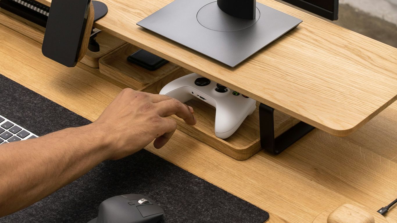 a person using a mouse and keyboard on a desk