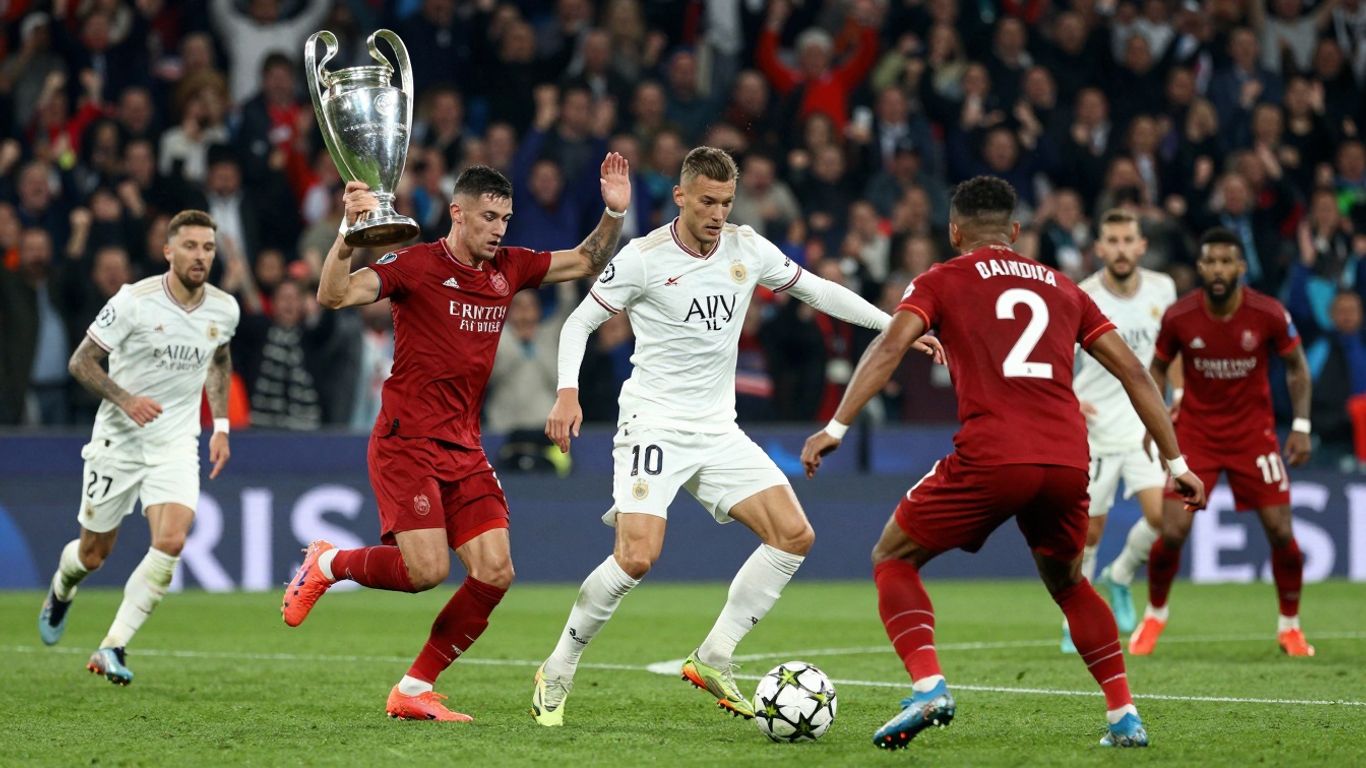 UEFA Champions League trophy and players in action.