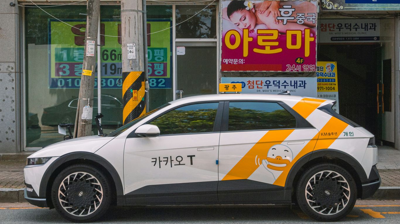 A kakao t taxi parked on a city street.