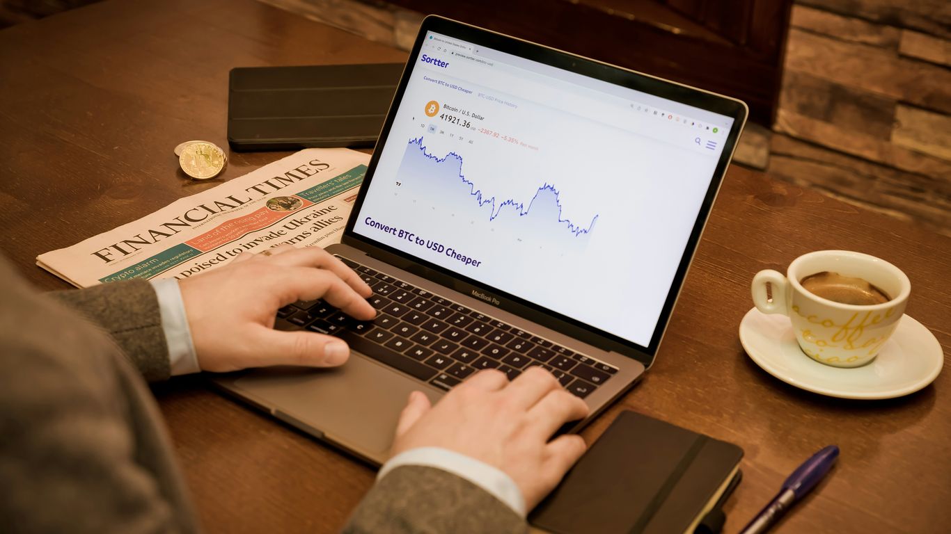 a person typing on a laptop on a table