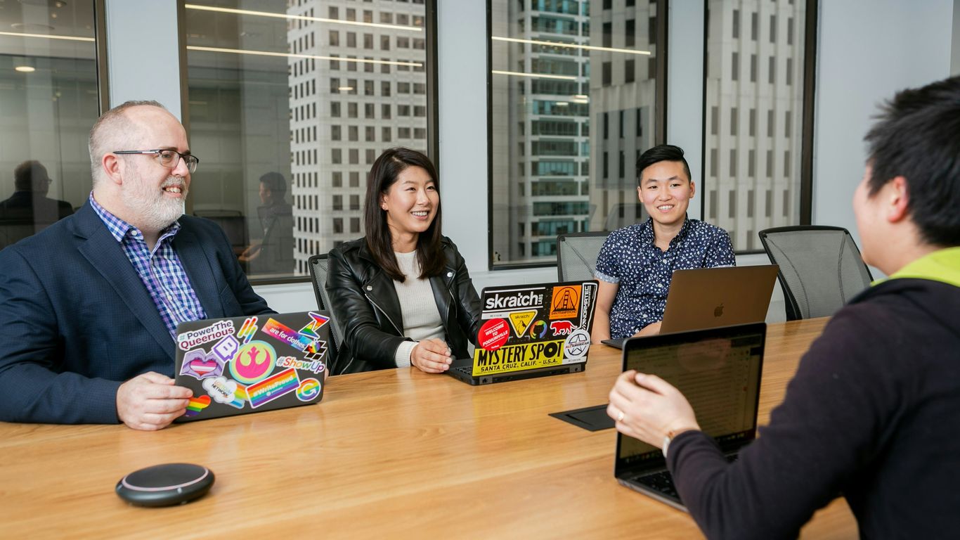 people in a design meeting in an office boardroom 