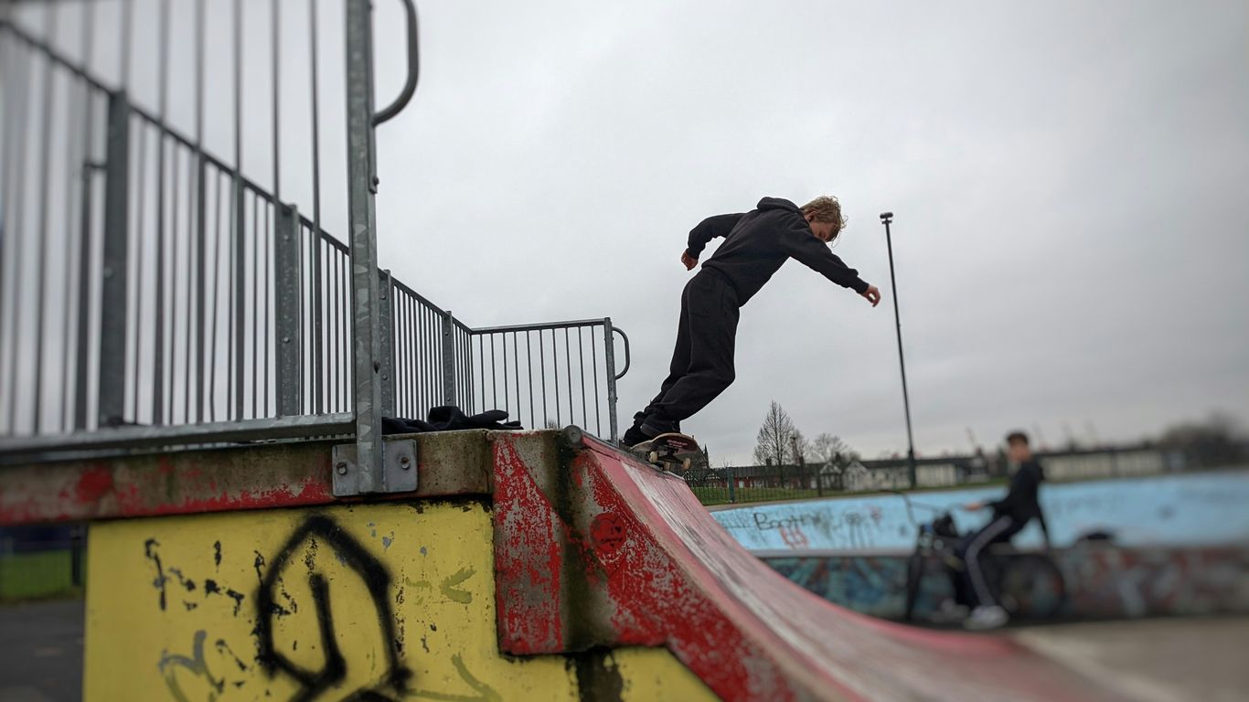 a man riding a skateboard up the side of a ramp