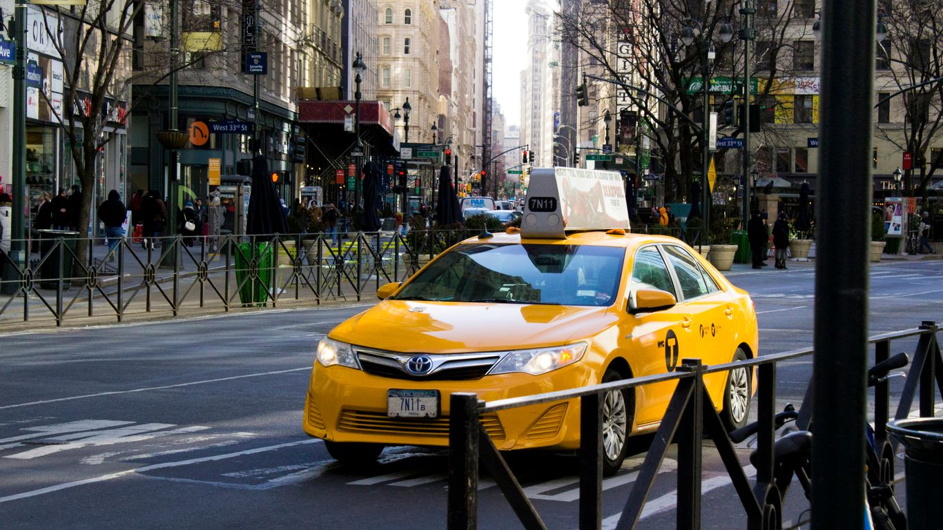 a yellow car on a street