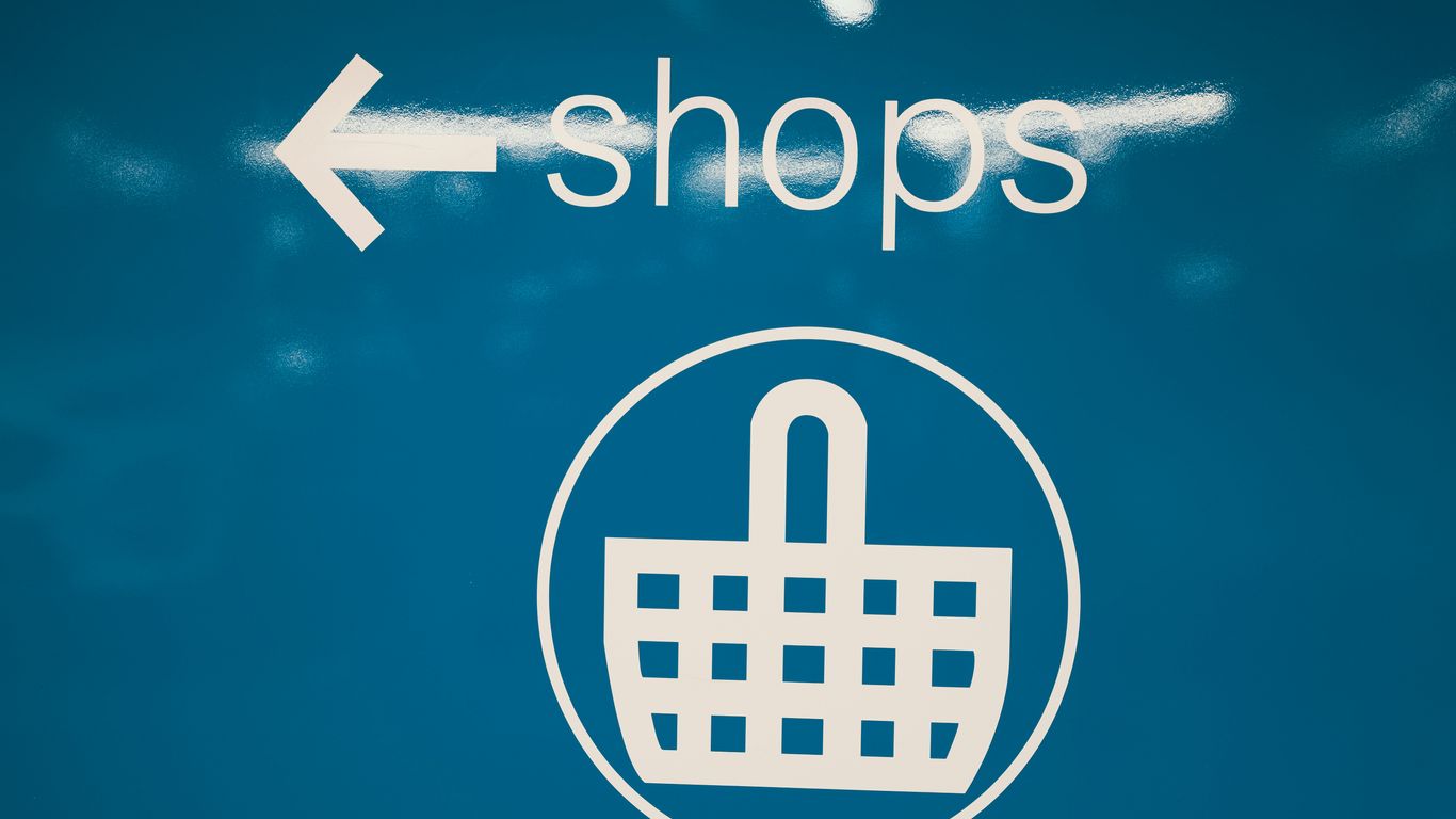 a blue sign with a shopping basket on it