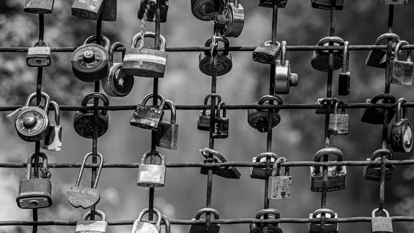 padlock on black metal fence