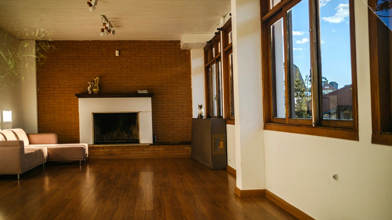 A living room with wood floors and a fire place