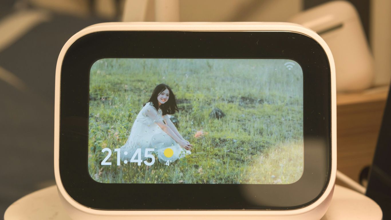 An alarm clock with a picture of a woman on it