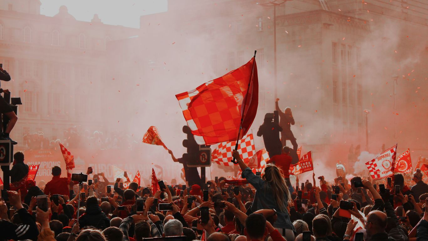 a large crowd of people holding flags and flags