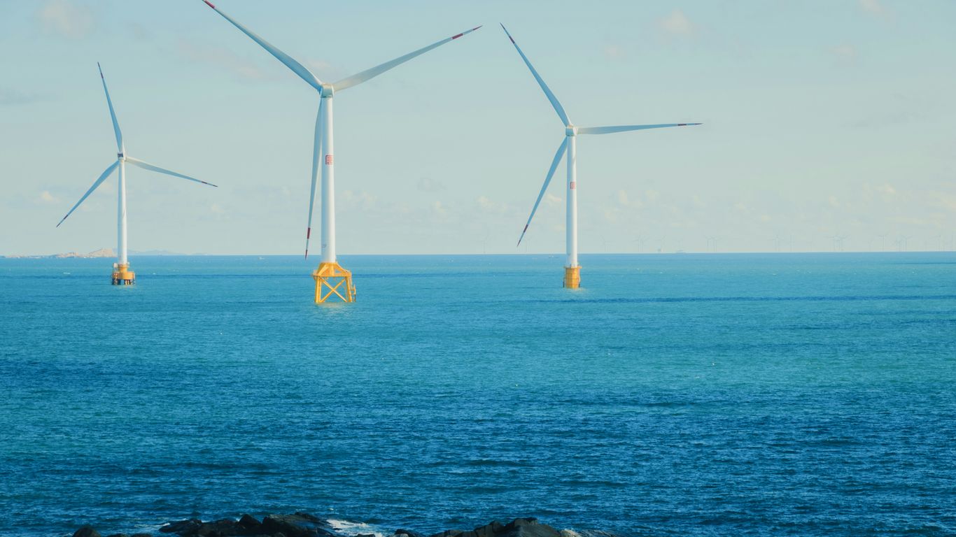 Wind turbines in the ocean on a clear day