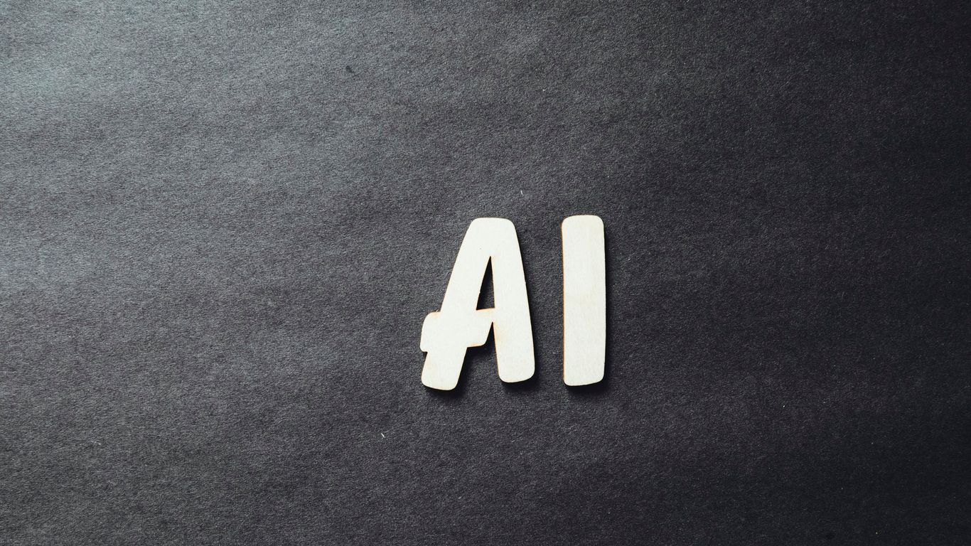 the word ai spelled in white letters on a black surface