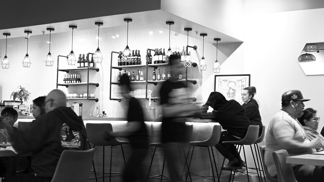Diners and staff at a busy restaurant bar