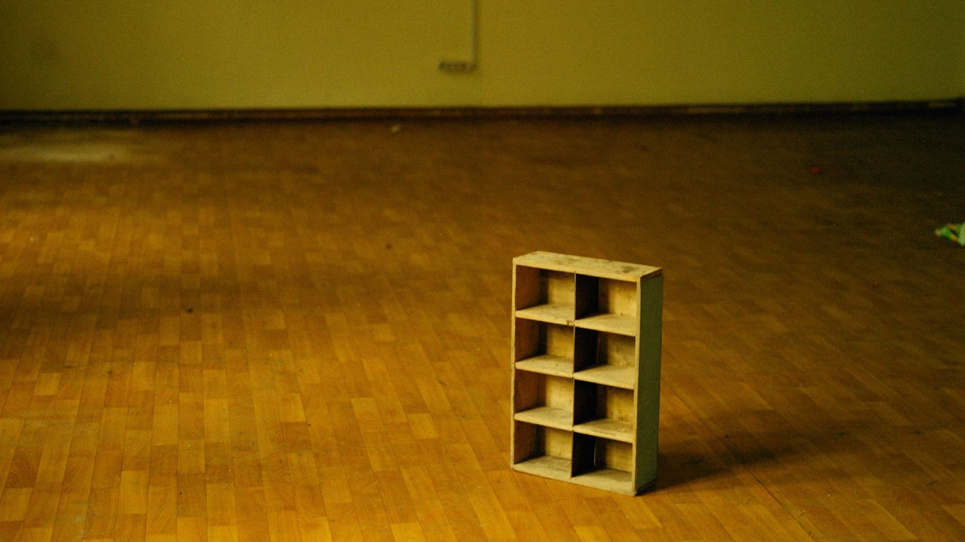 a book shelf sitting on a hard wood floor