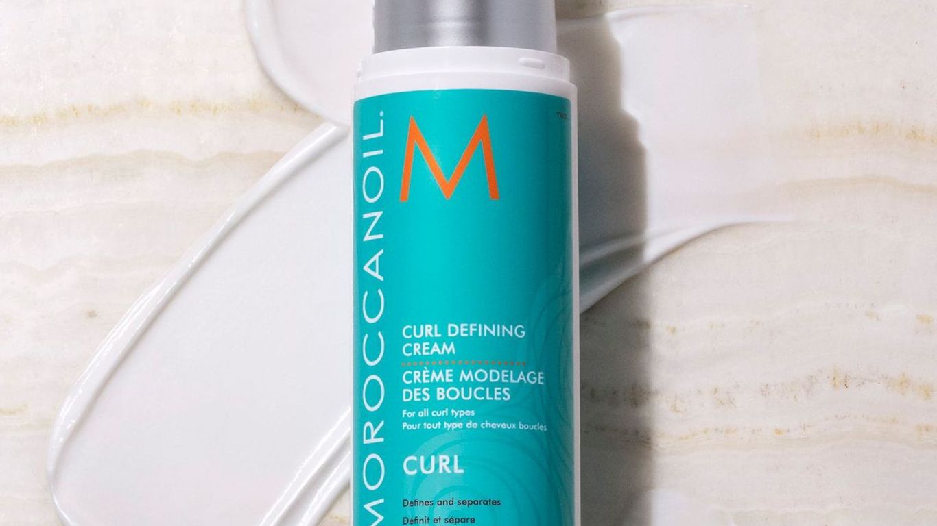 Bottle of Moroccanoil Curl Defining Cream on a textured surface.
