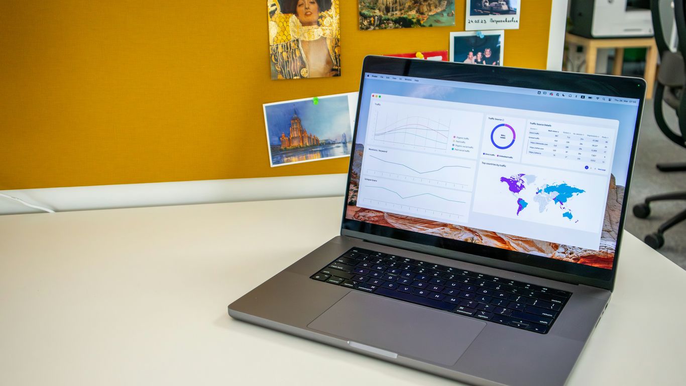 a laptop computer sitting on top of a white desk