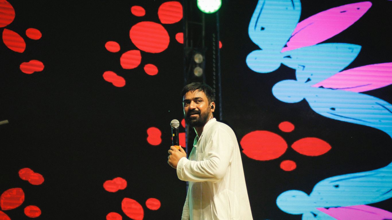 A man standing on a stage holding a microphone