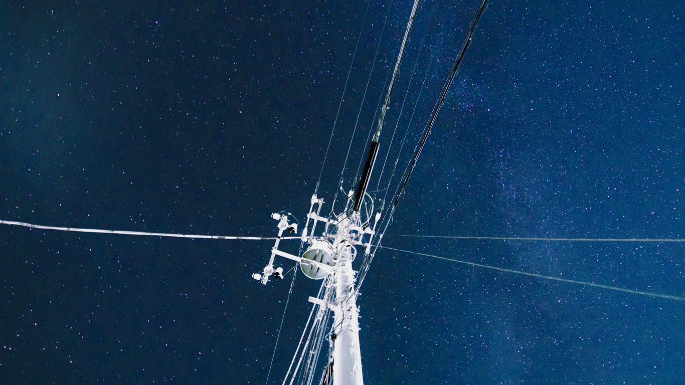 white electric post under blue sky during night time