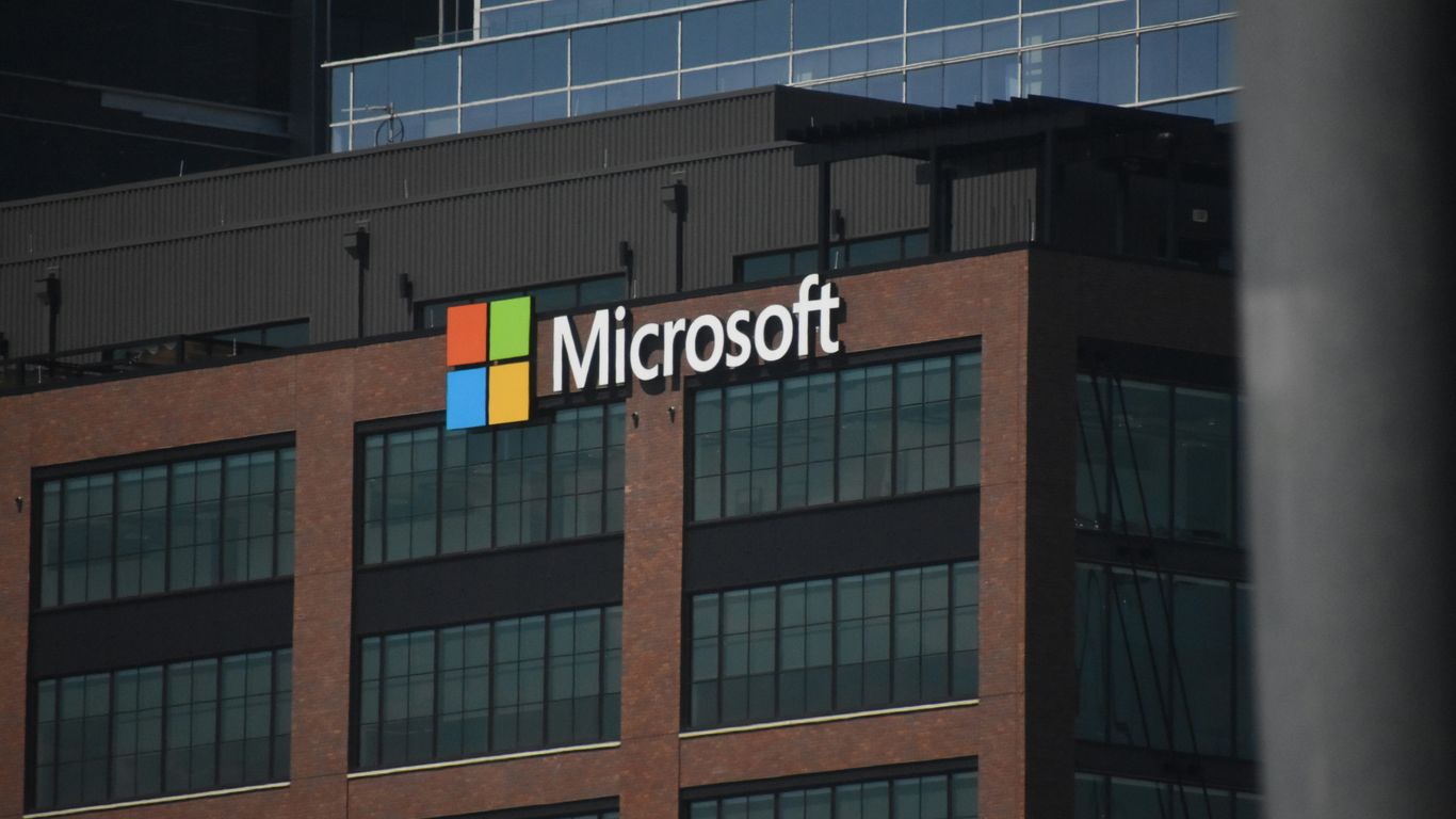 A tall building with a microsoft logo on top of it