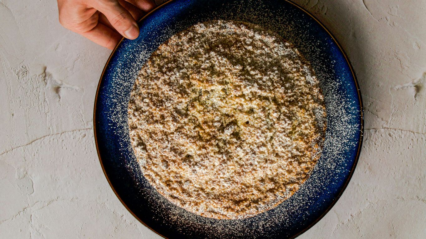 a person holding a plate of food on a table