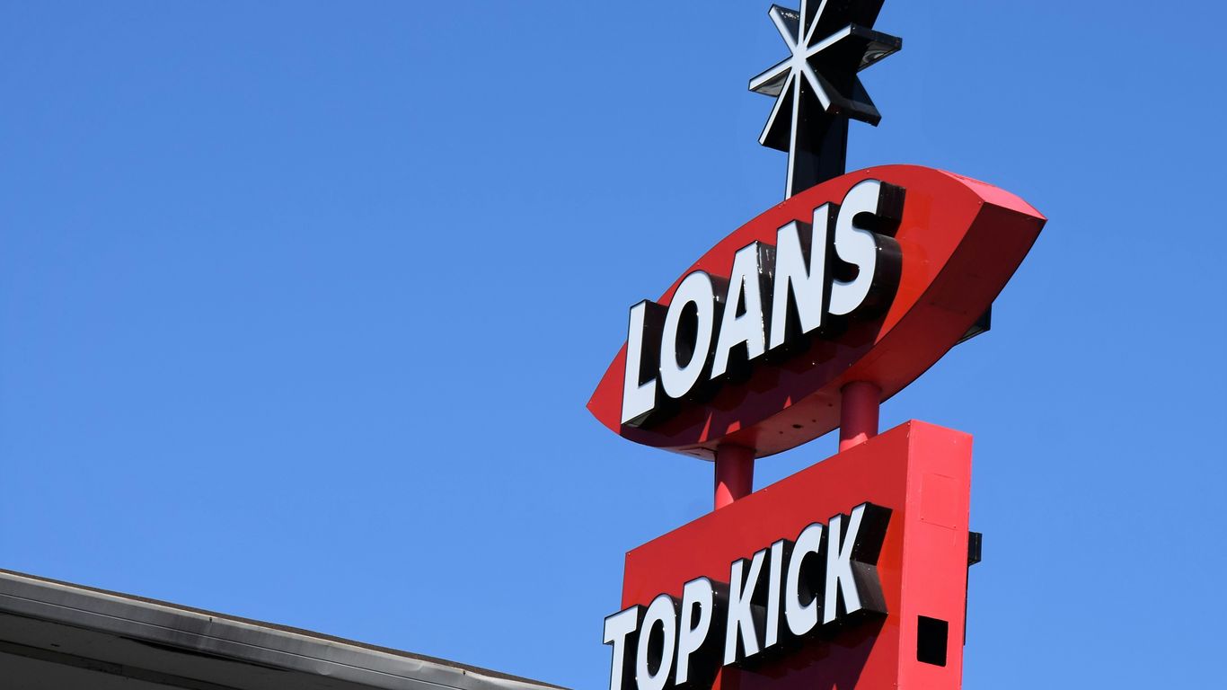 a sign for a top kick store against a blue sky