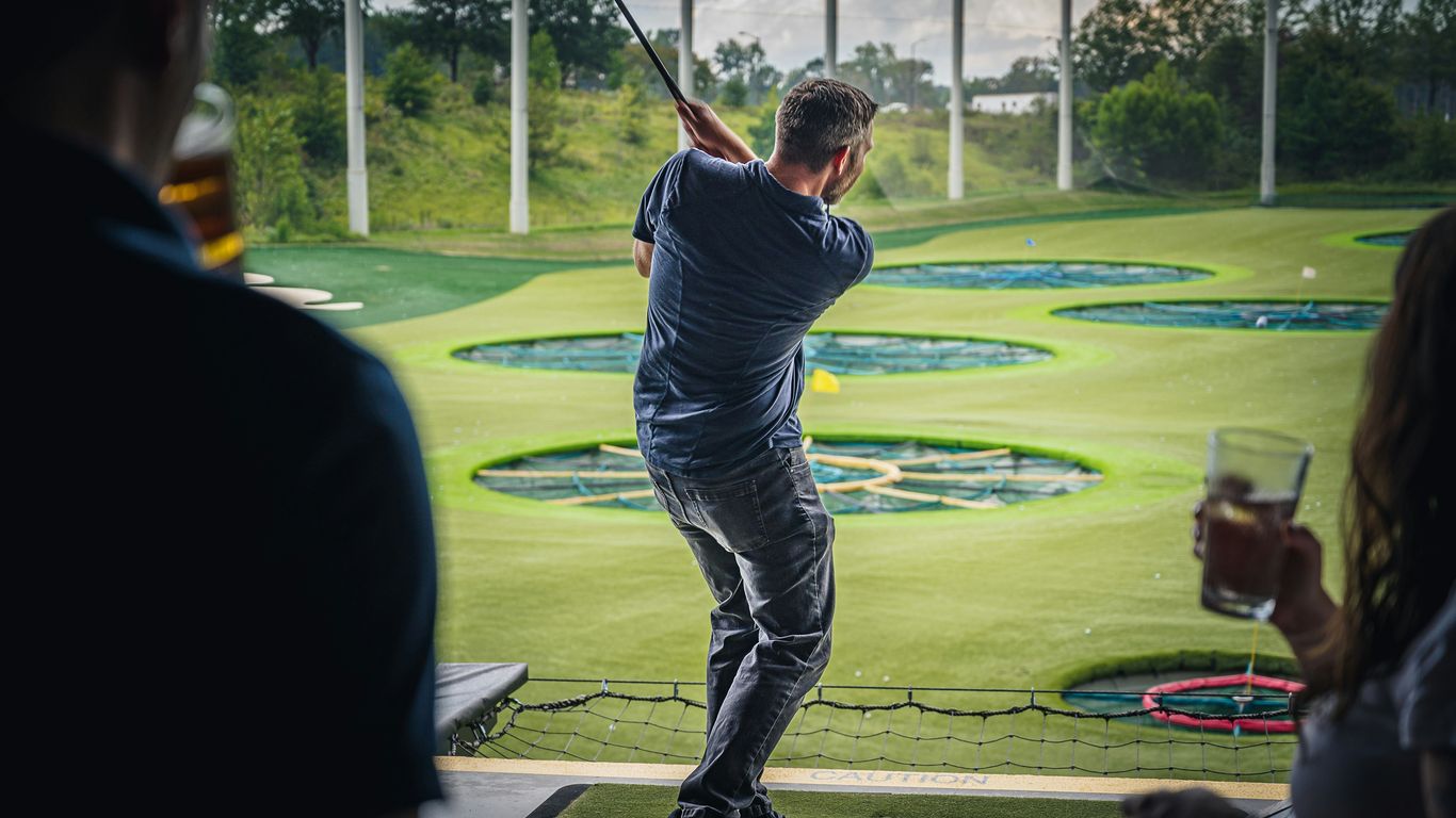 a person swinging a golf club