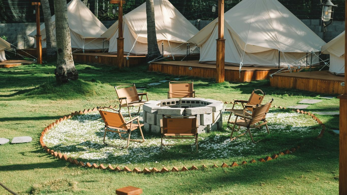 a fire pit in the middle of a grassy area
