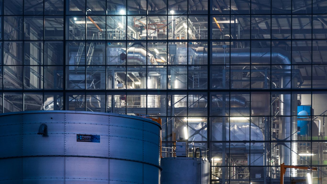 a large building with a lot of pipes in front of it