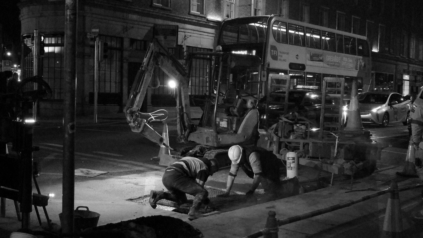 Workers are repairing the street at night.