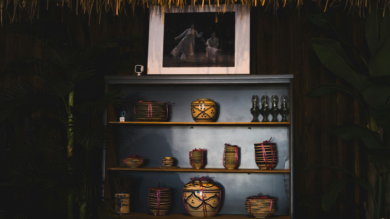 A hut with a shelf full of items