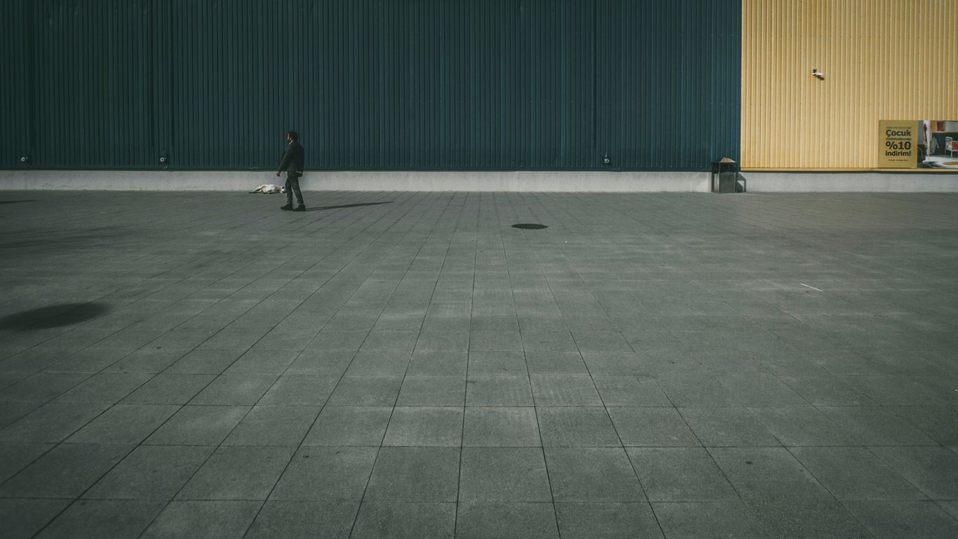 person walking on concrete pavement