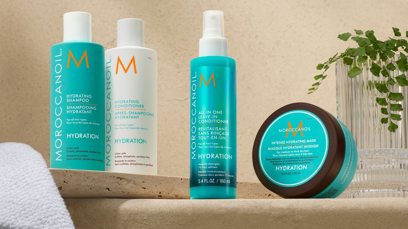 Haircare products displayed on a shelf with a neutral background.