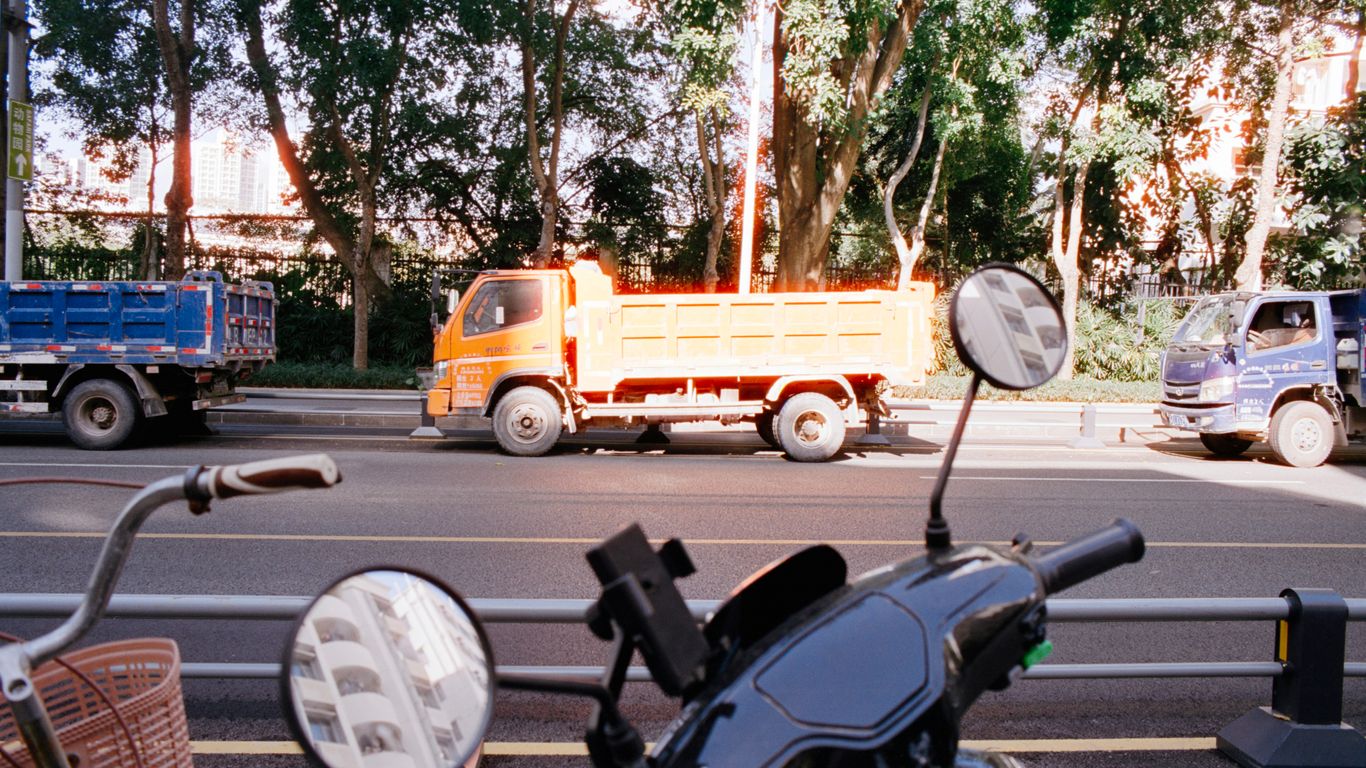 Orange dump truck on a sunny street