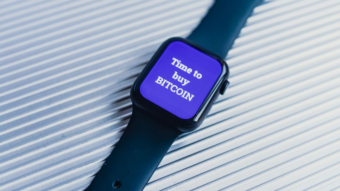 A smartwatch displaying a message about buying Bitcoin.