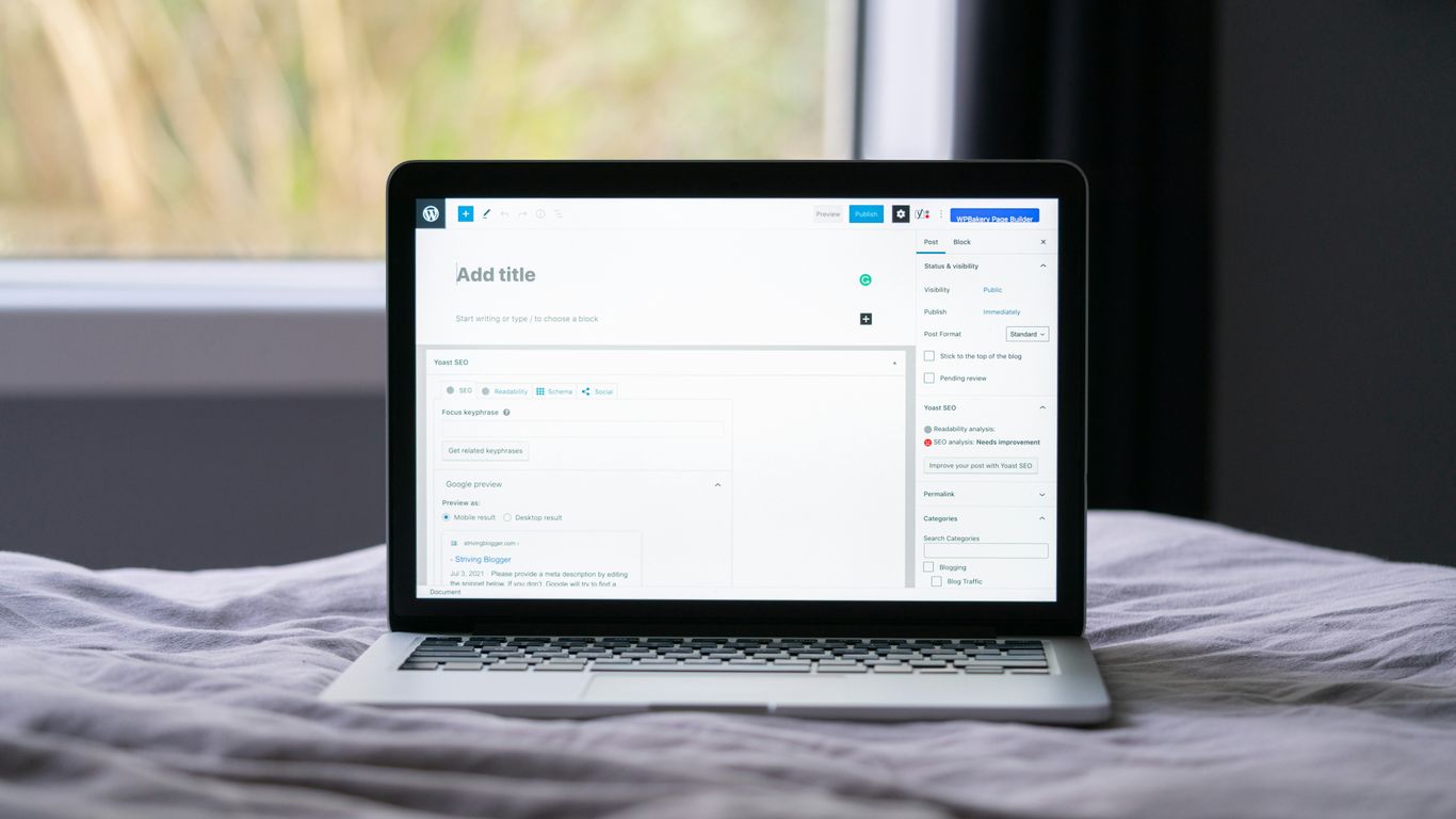 black and silver laptop computer on white textile