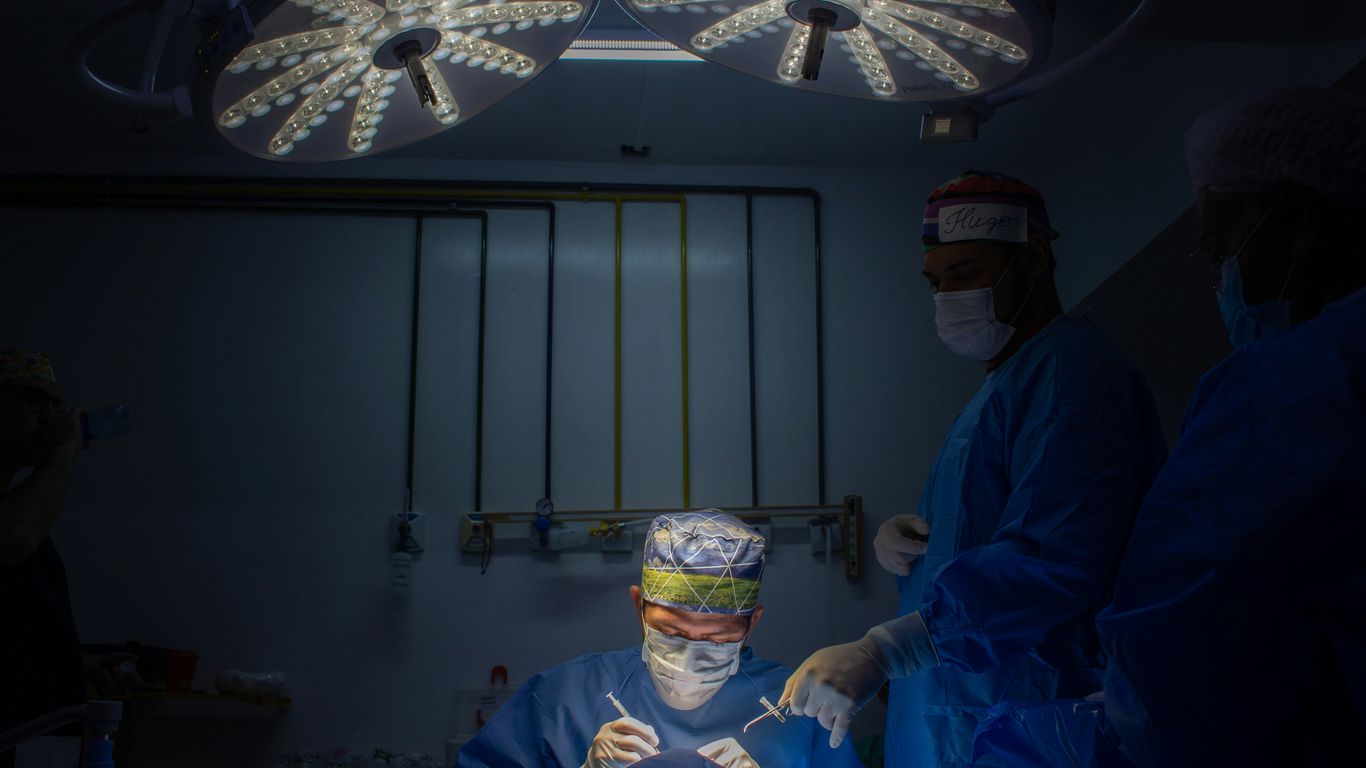 a group of doctors in scrubs in a dark room