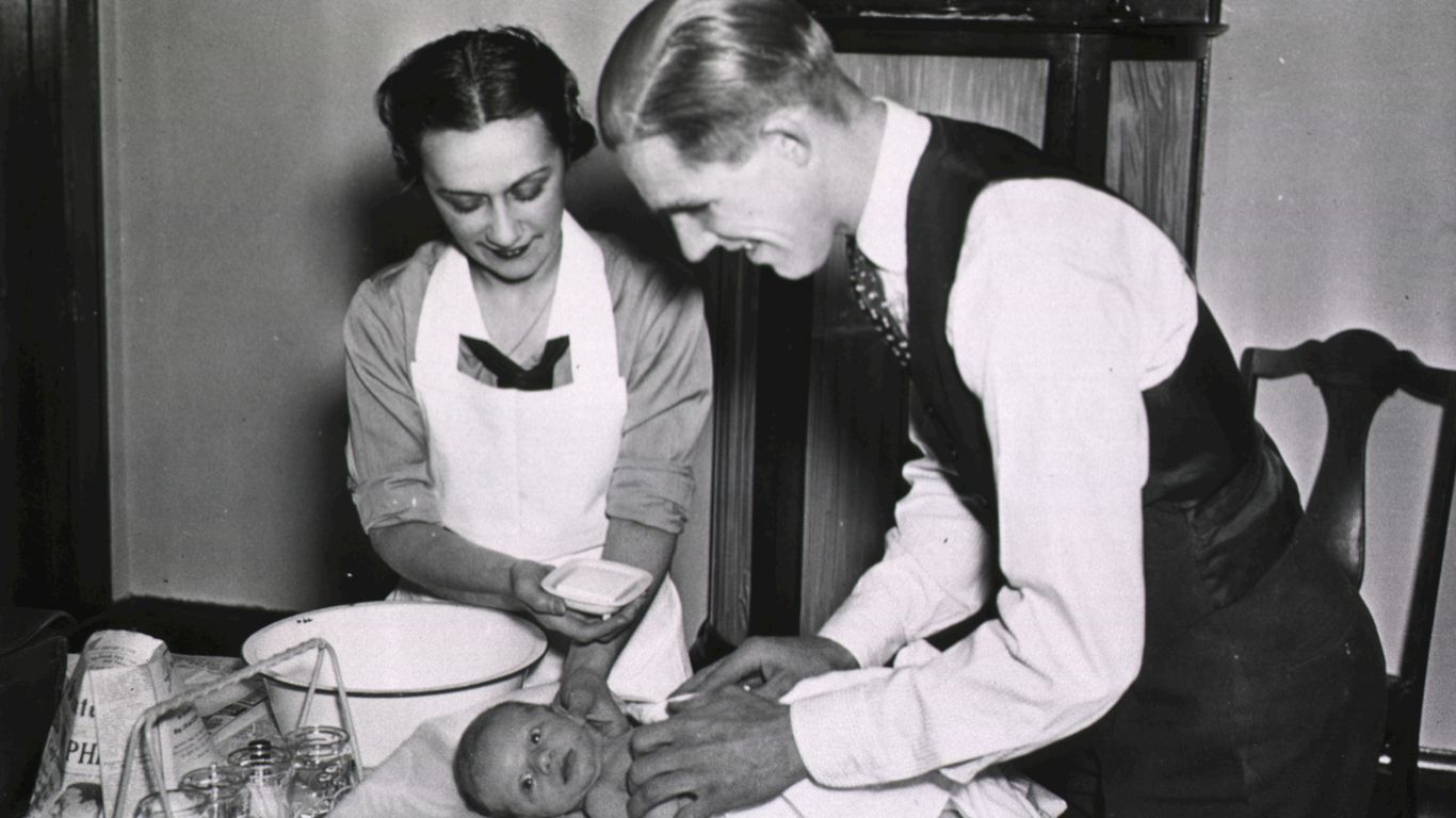 a man and a woman are preparing a baby