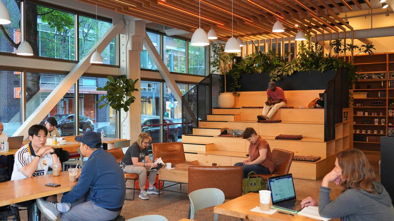 People relax and work in a cozy cafe.