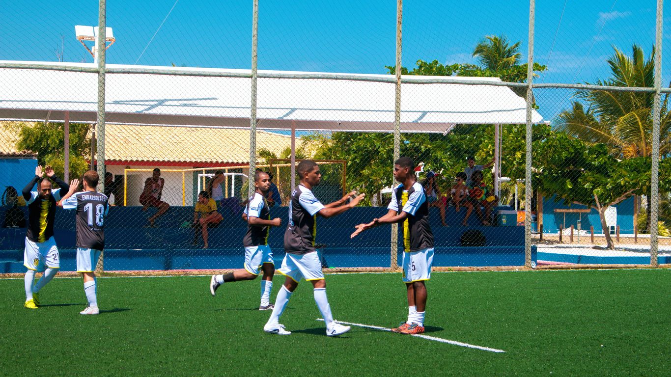 group of women playing soccer during daytime