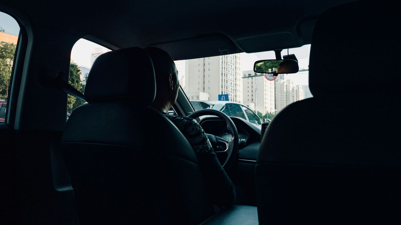a man driving a car in the dark