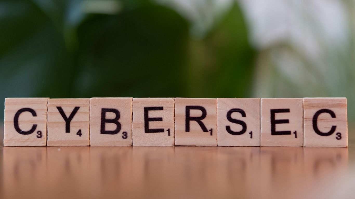 A wooden block spelling cybersec on a table