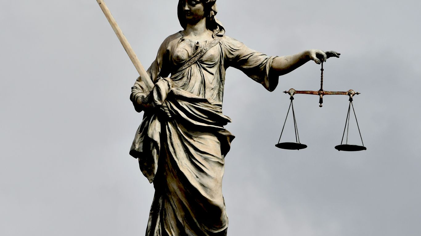 A statue of lady justice holding a sword and a scale