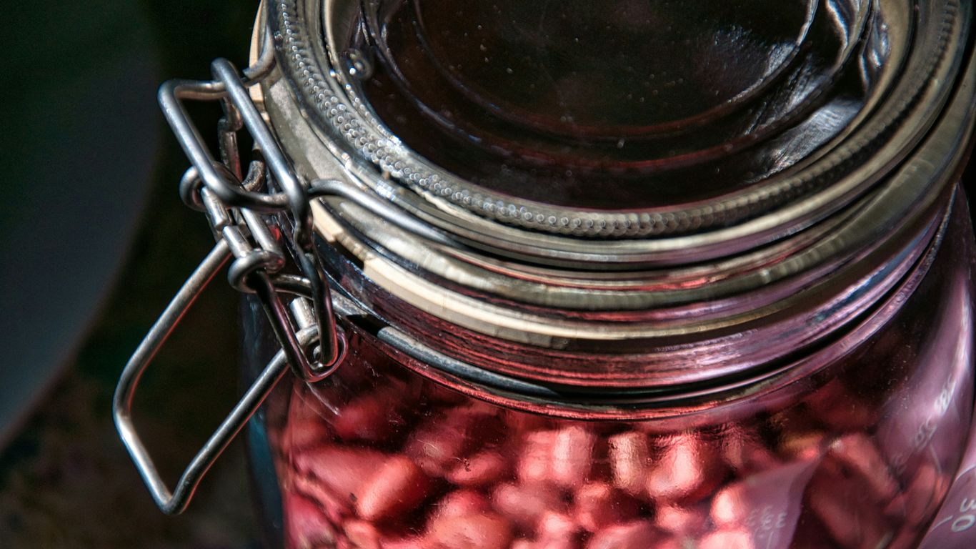 a jar filled with lots of pink candy