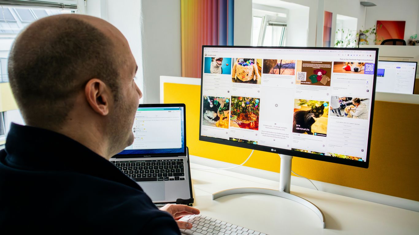 a man sitting in front of a computer monitor