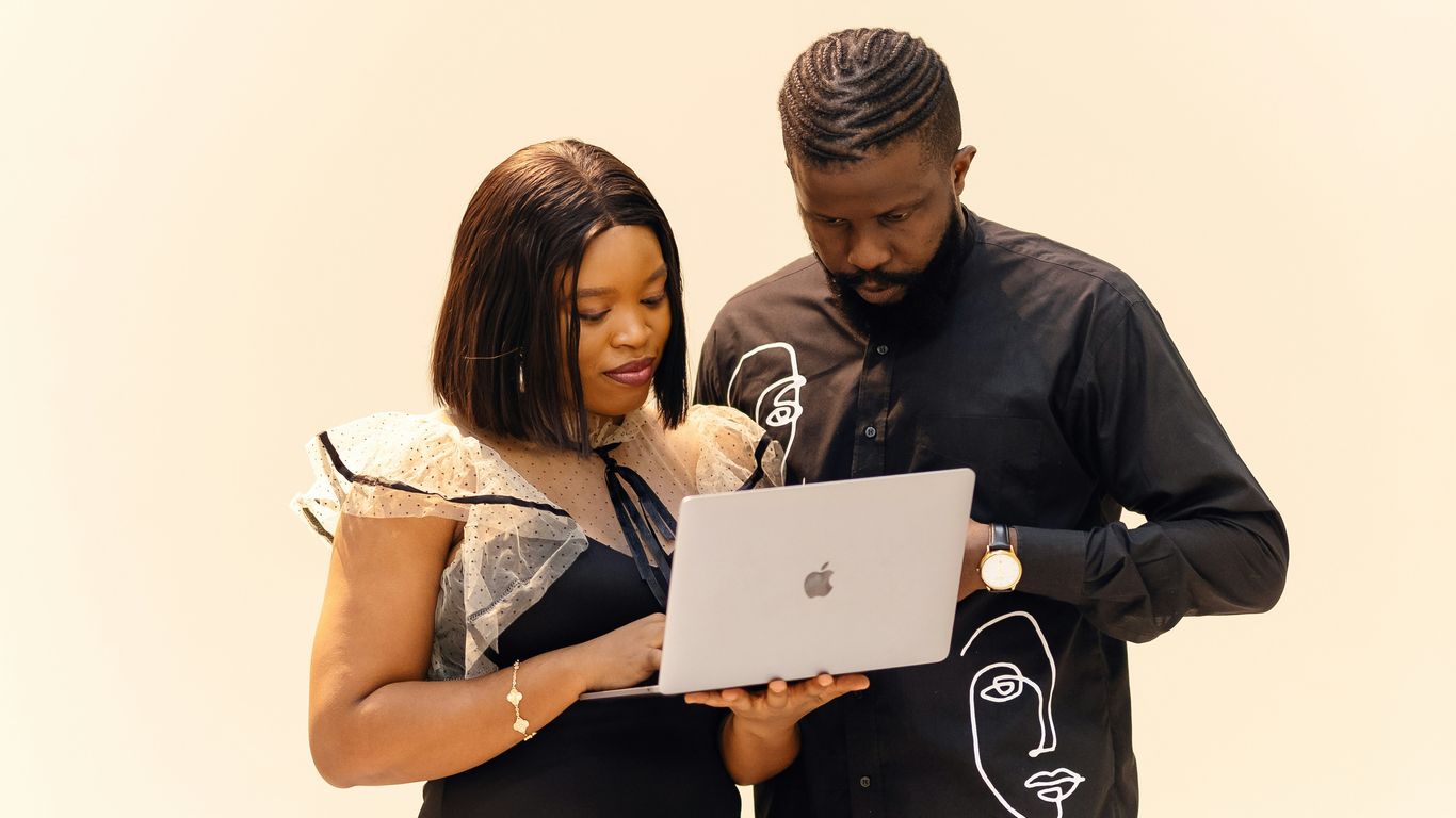 A man and a woman looking at a laptop