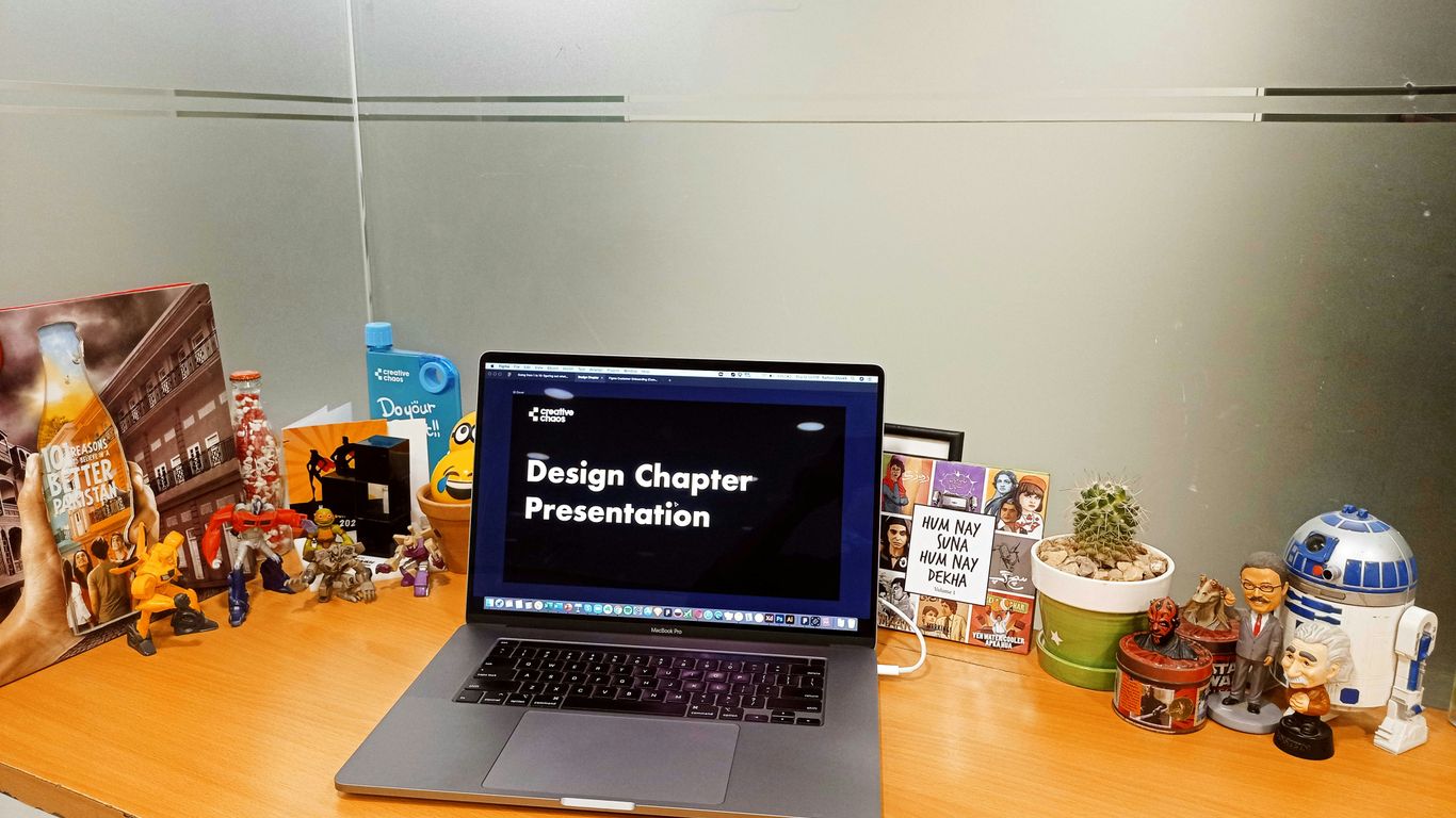 a laptop computer sitting on top of a wooden desk