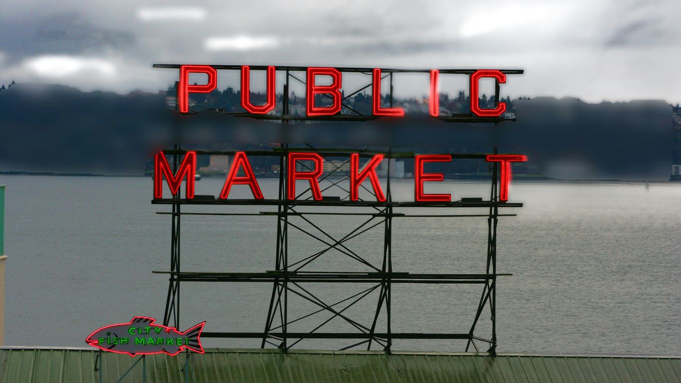 a sign that reads public market on a cloudy day