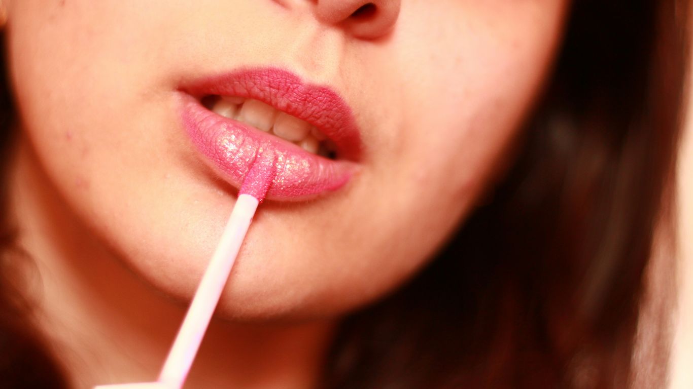 A woman holding a straw in her mouth