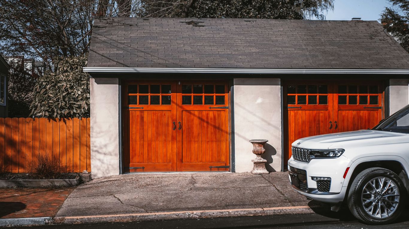 a white truck parked in front of a garage